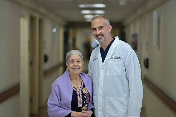 male physician in a white lab coat with a female patient